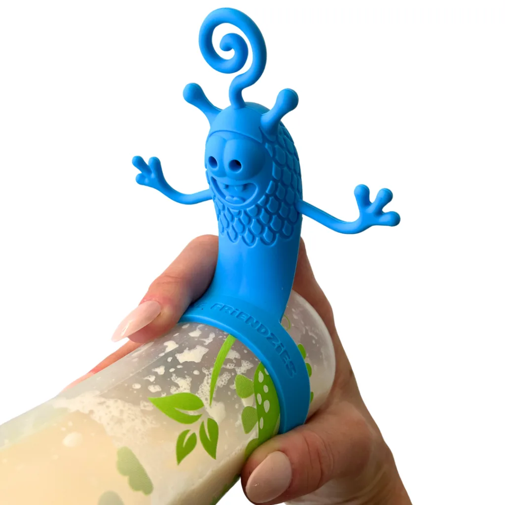 Feeding Friendzies interactive toy for baby bottles on a filled baby bottle held in a hand facing foward in blue