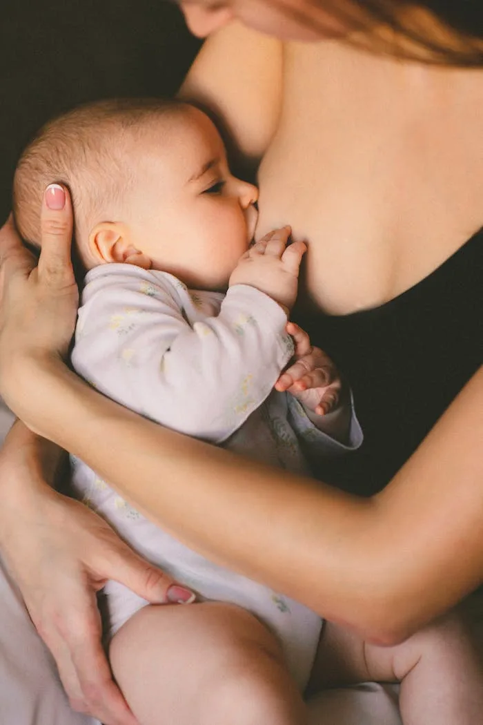Baby breastfeeding from its mother.